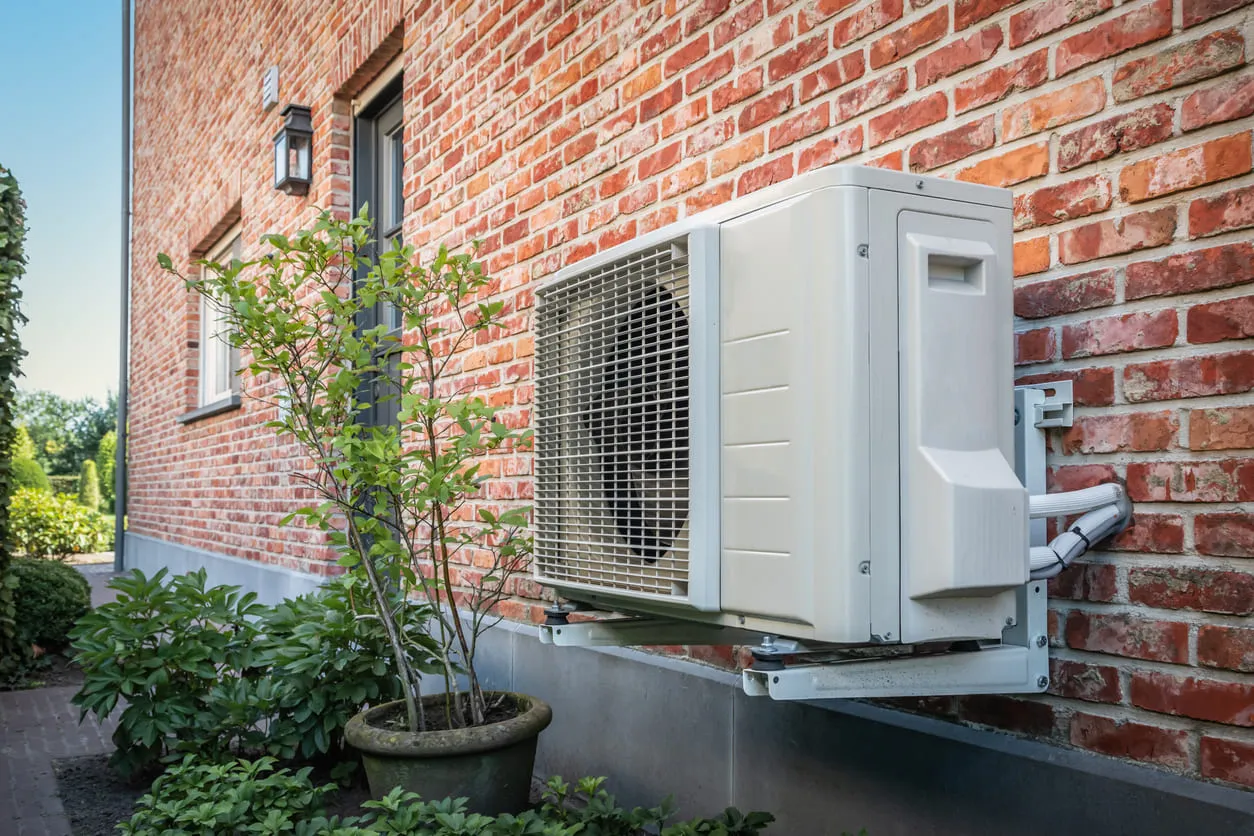Heat Pump Against Brick Wall