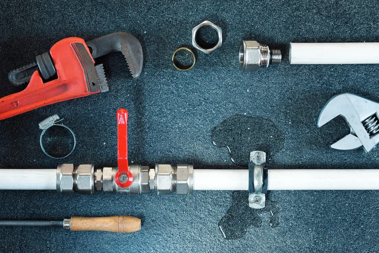 Plumber Using Wrench on Bathroom Sink