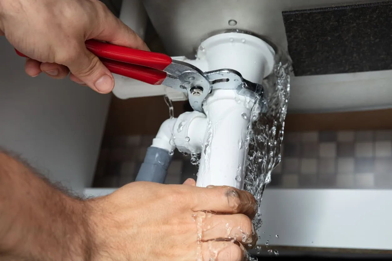 Plumber Fixing Kitchen Sink