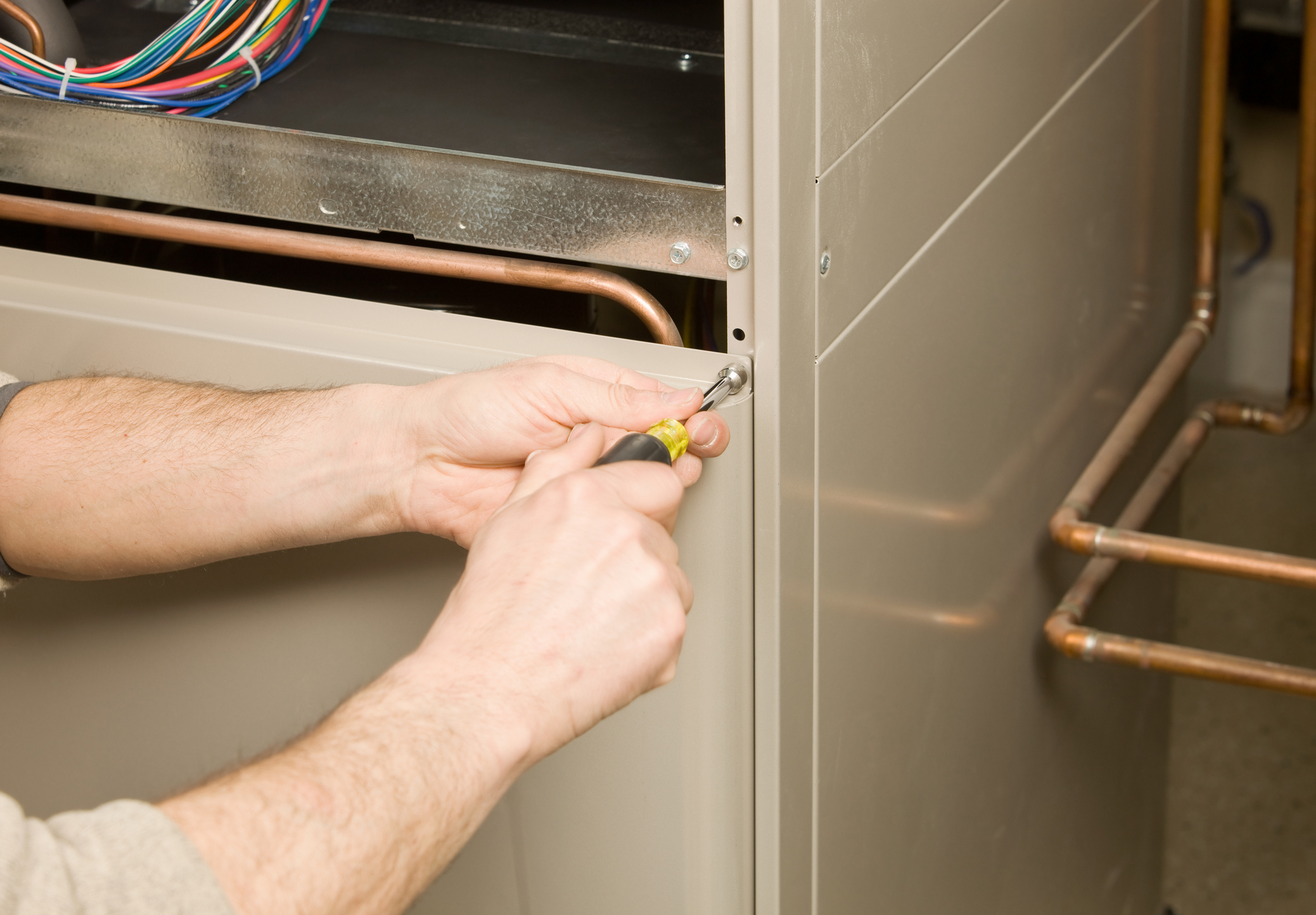 Tech Removing Furnace Service Panel